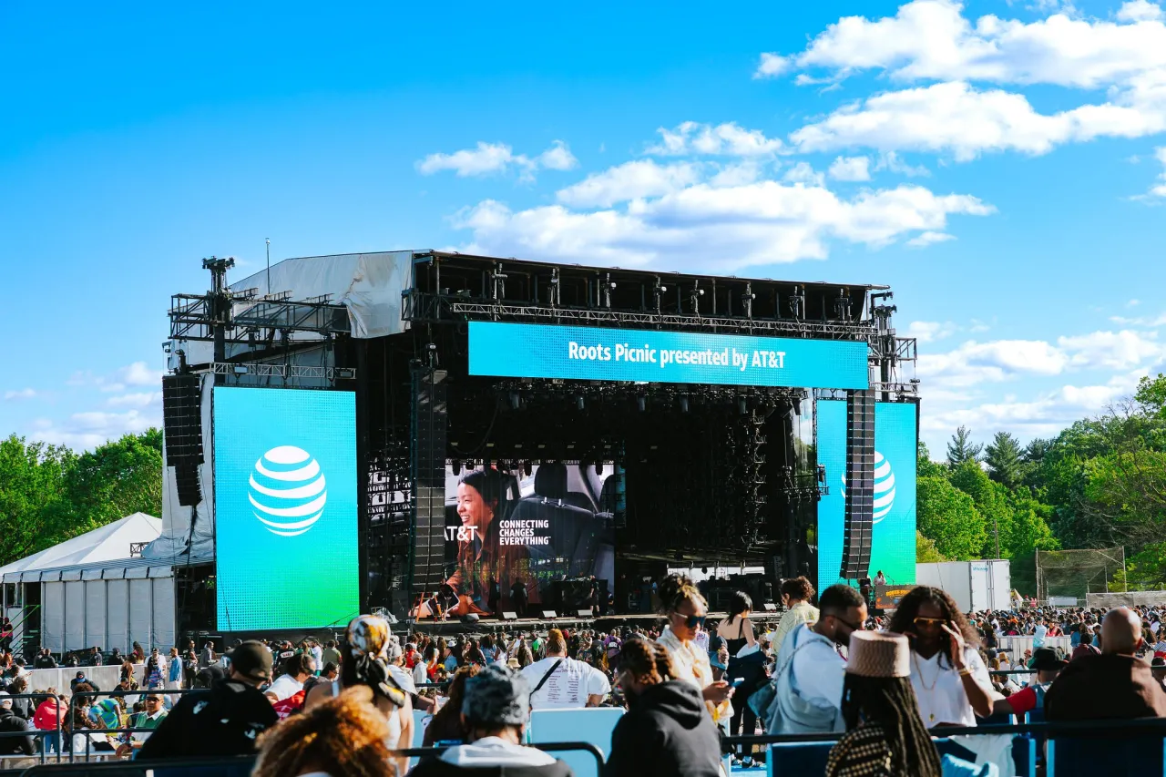Roots Picnic main stage presented by AT&T beneath a bright blue sky.