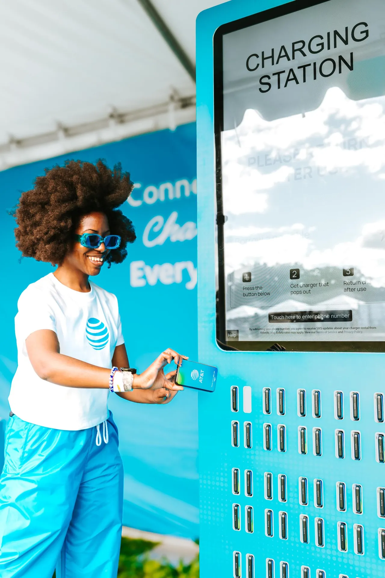 AT&T team member demonstrating the charging station at Roots Picnic.