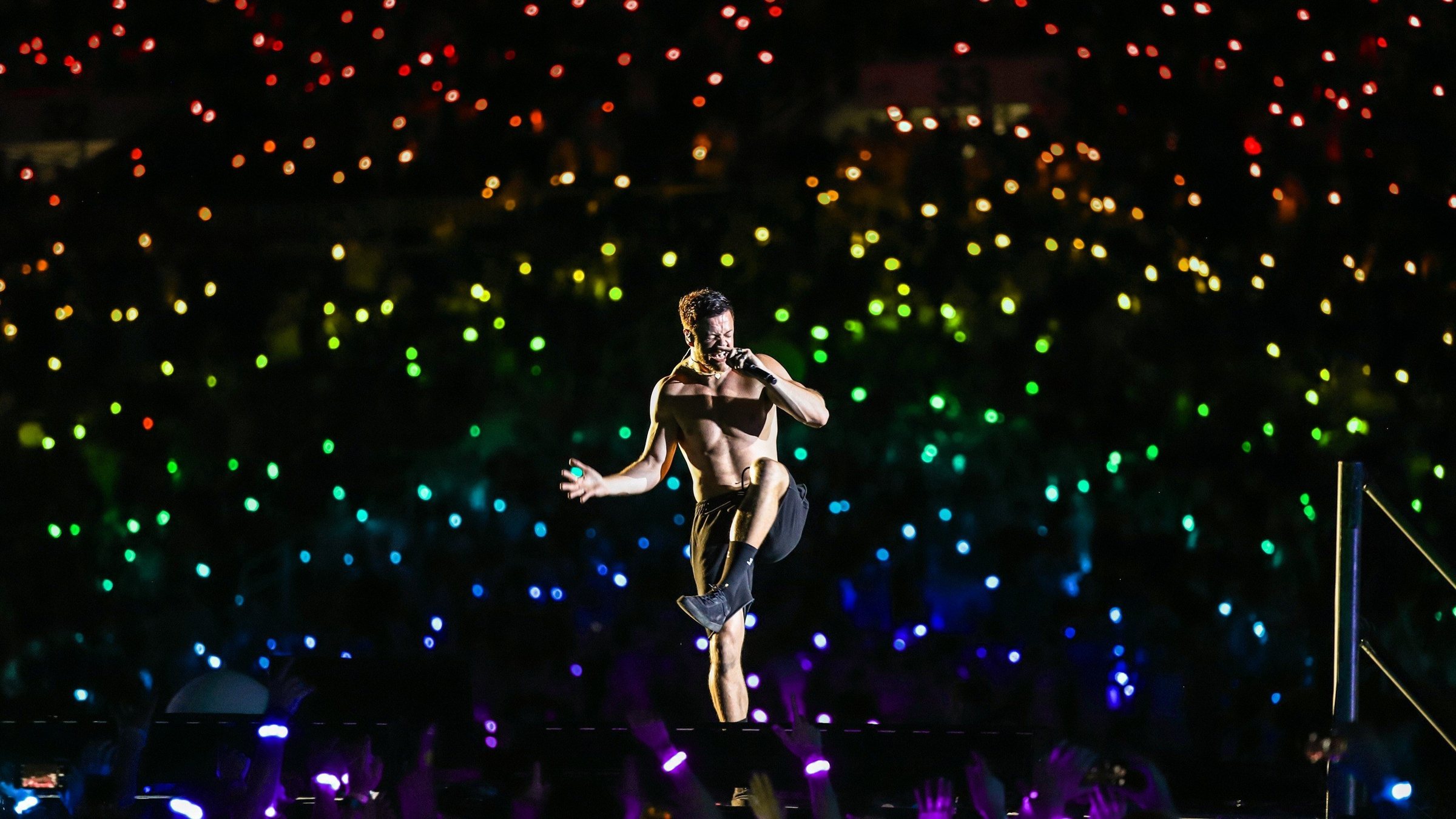Dan Reynolds with fans wearing rainbow wristbands at LOVELOUD