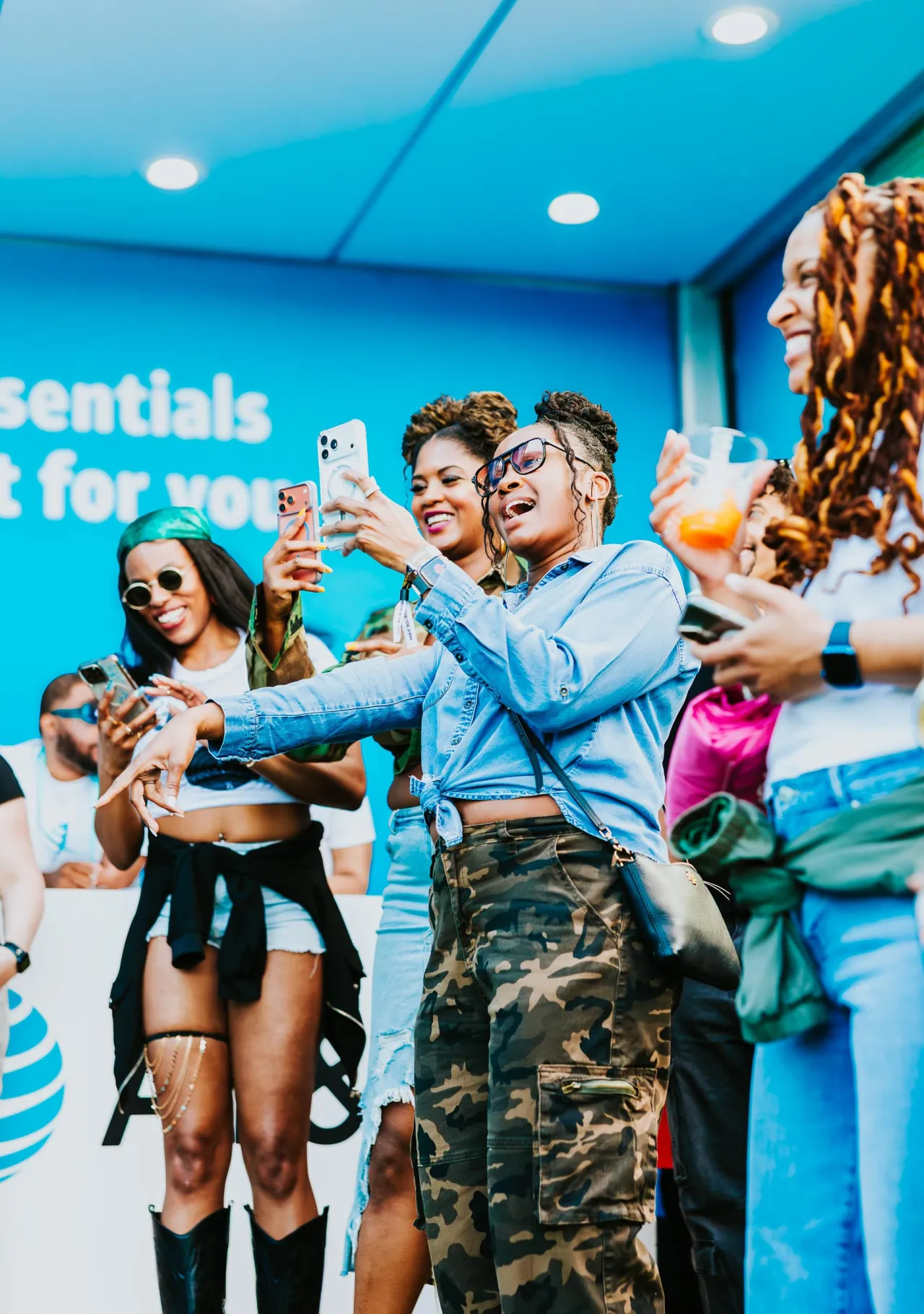 Festival guests dancing and recording a moment inside the AT&T Blue Room.