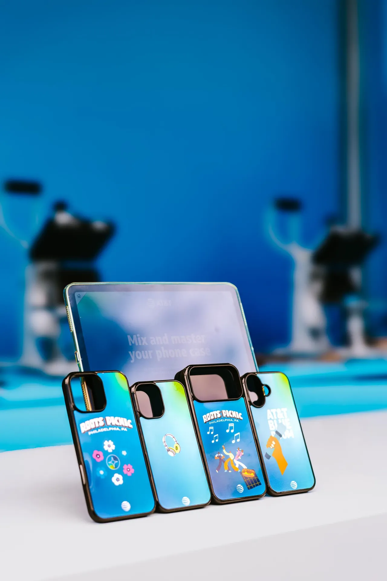 Custom Roots Picnic phone cases displayed inside the AT&T experience.