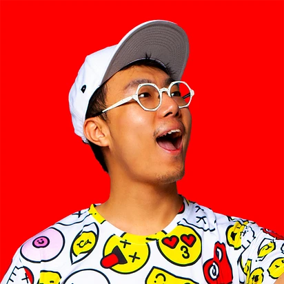 Portrait of Zipeng Zhu, artist and designer, in a white cap and patterned shirt against a red background