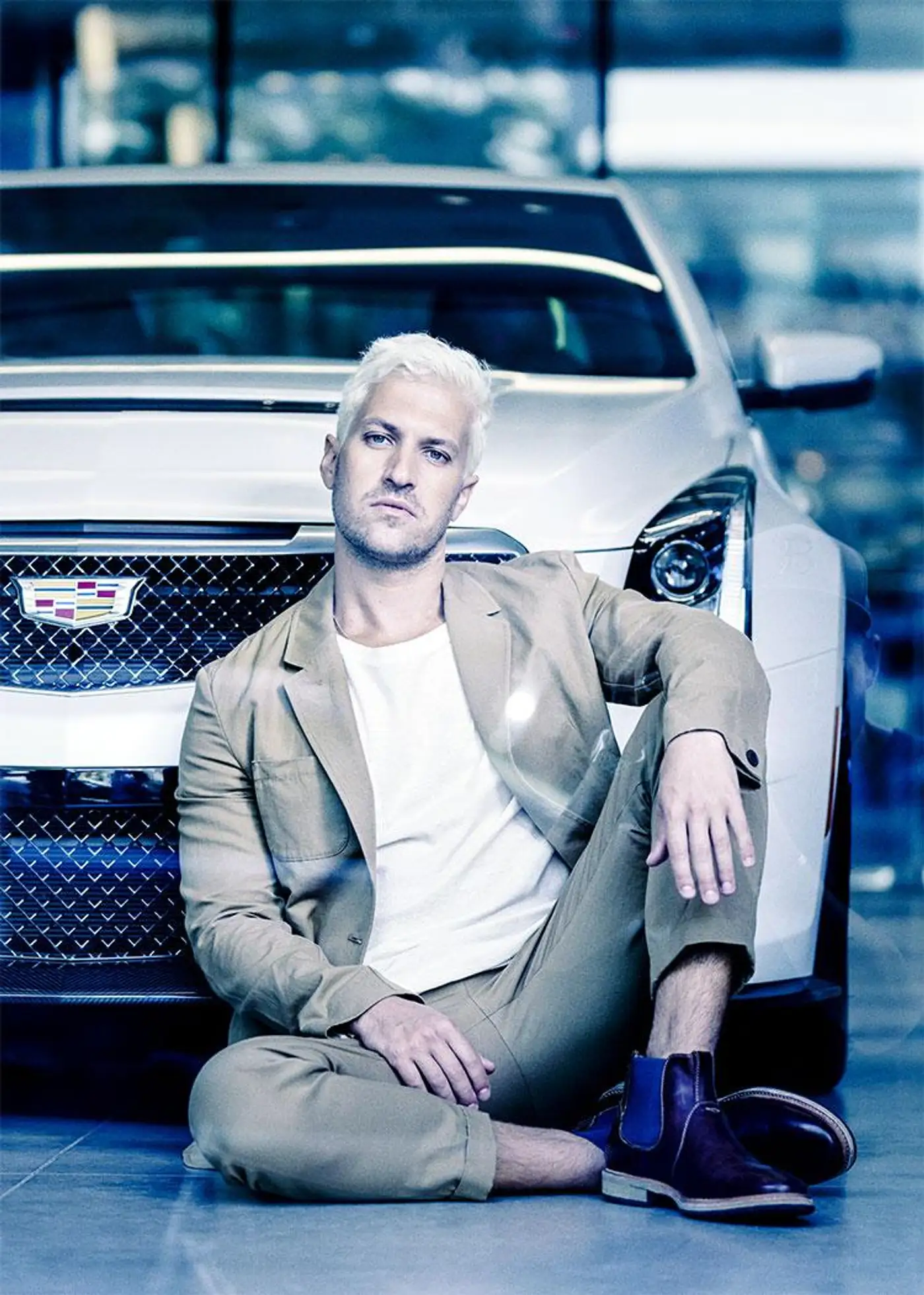 Master of Style editorial photography, seated portrait in front of a Cadillac.