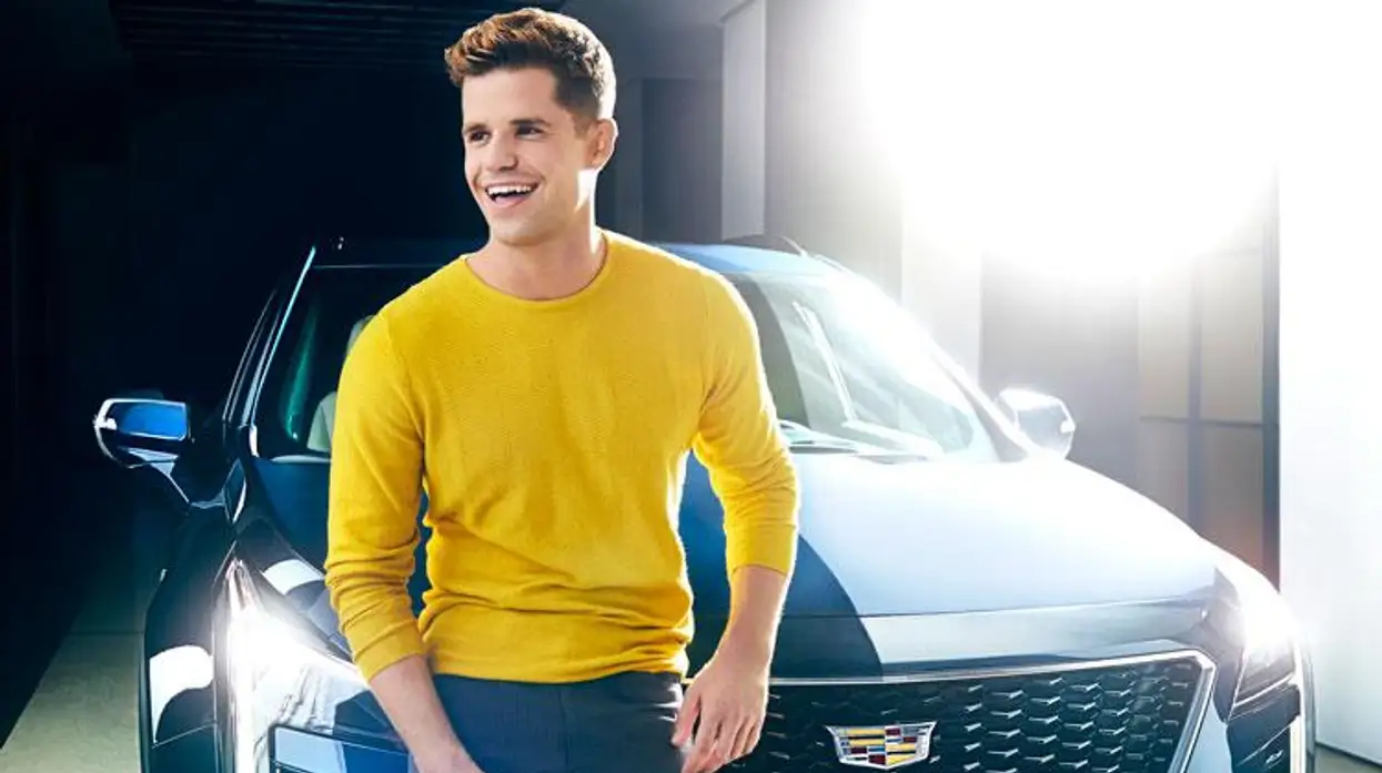 Charlie Carver photographed with the Cadillac XT4.