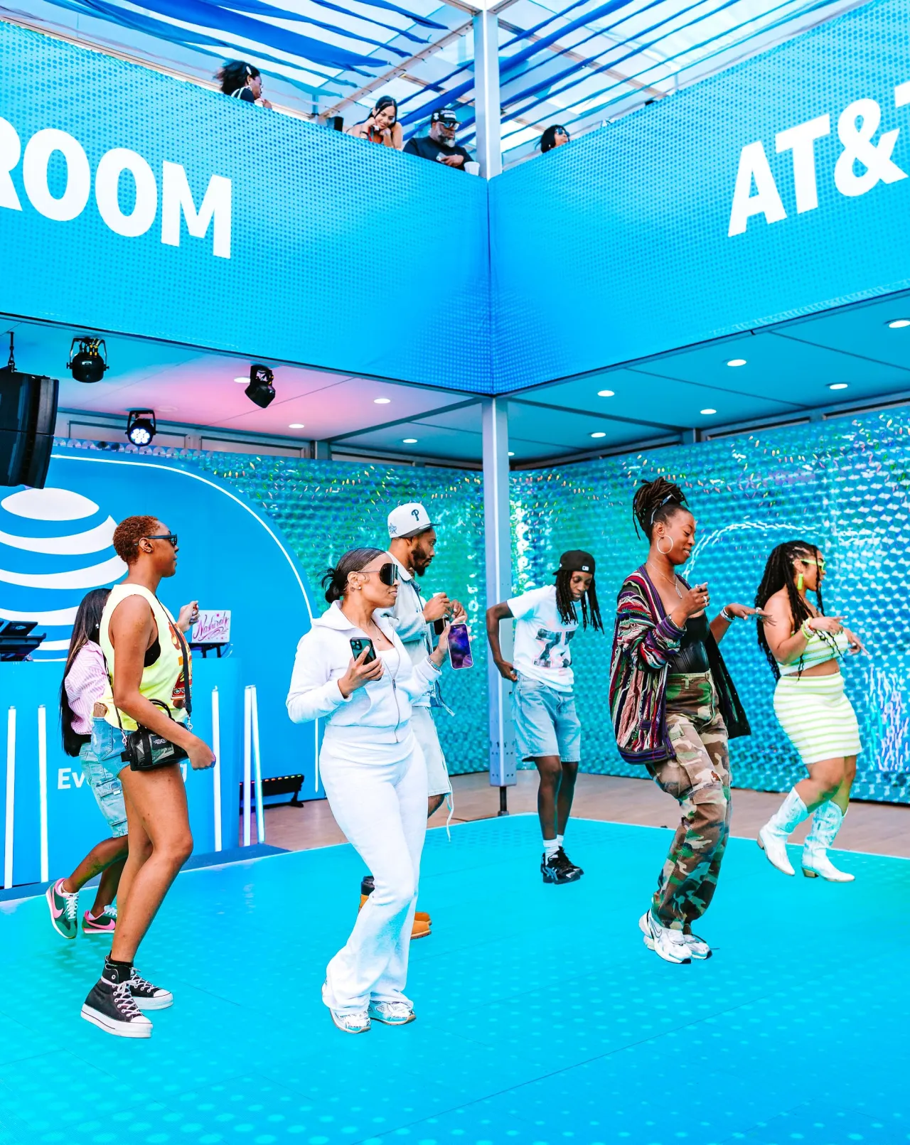 Festival guests dancing together on the floor of the AT&T Blue Room.